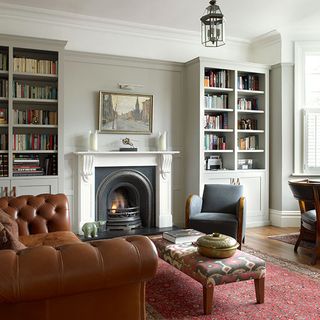 living room of edwardian home with fireplace sofas and bookcases