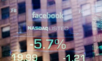 Facebook's falling stock price is seen on a screen reflected in the window of the Nasdaq building in New York City, Aug. 16.