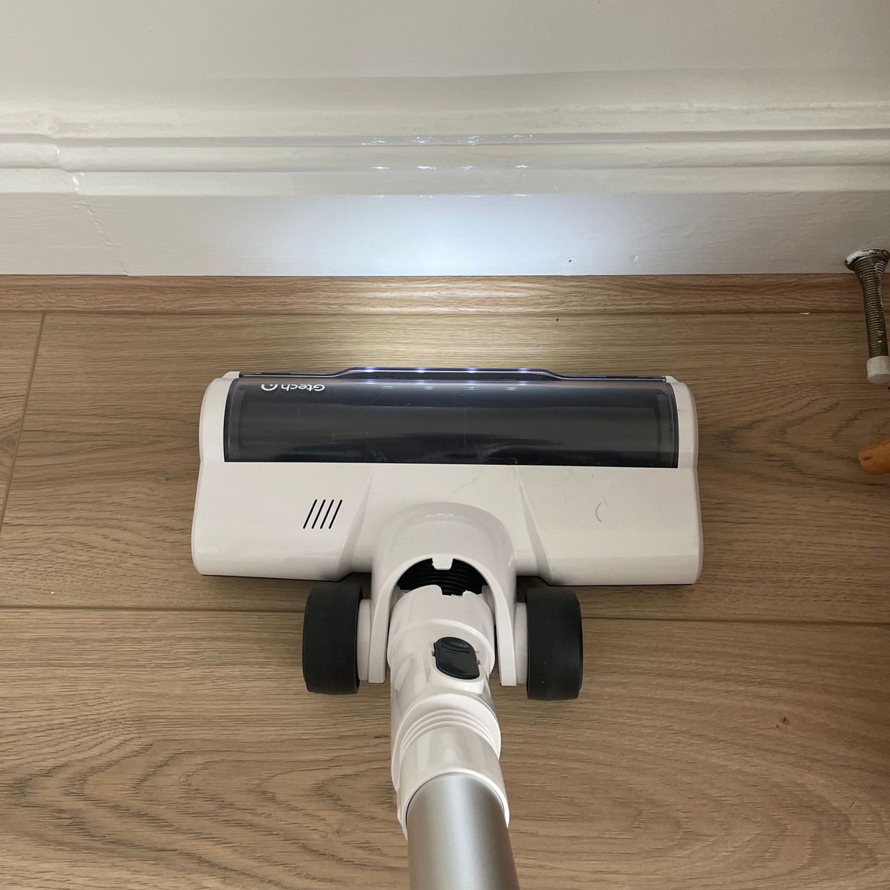 Gtech AirFOX Platinum Cordless Vacuum lights reflecting on white skirting boards