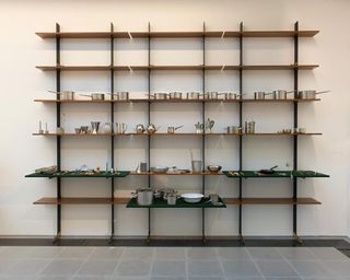 Shelving unit with various silver items on display