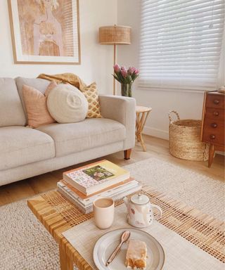 A cream small living room with a gray couch and coffee table