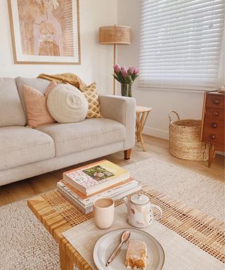 A small living room with a creamcouch and wooden coffee table