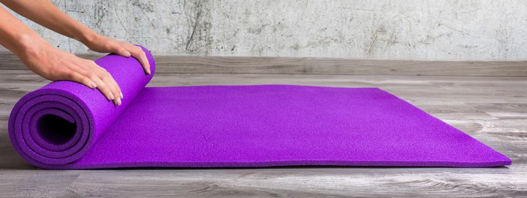 Low Section Of Person Rolling Yoga Ma