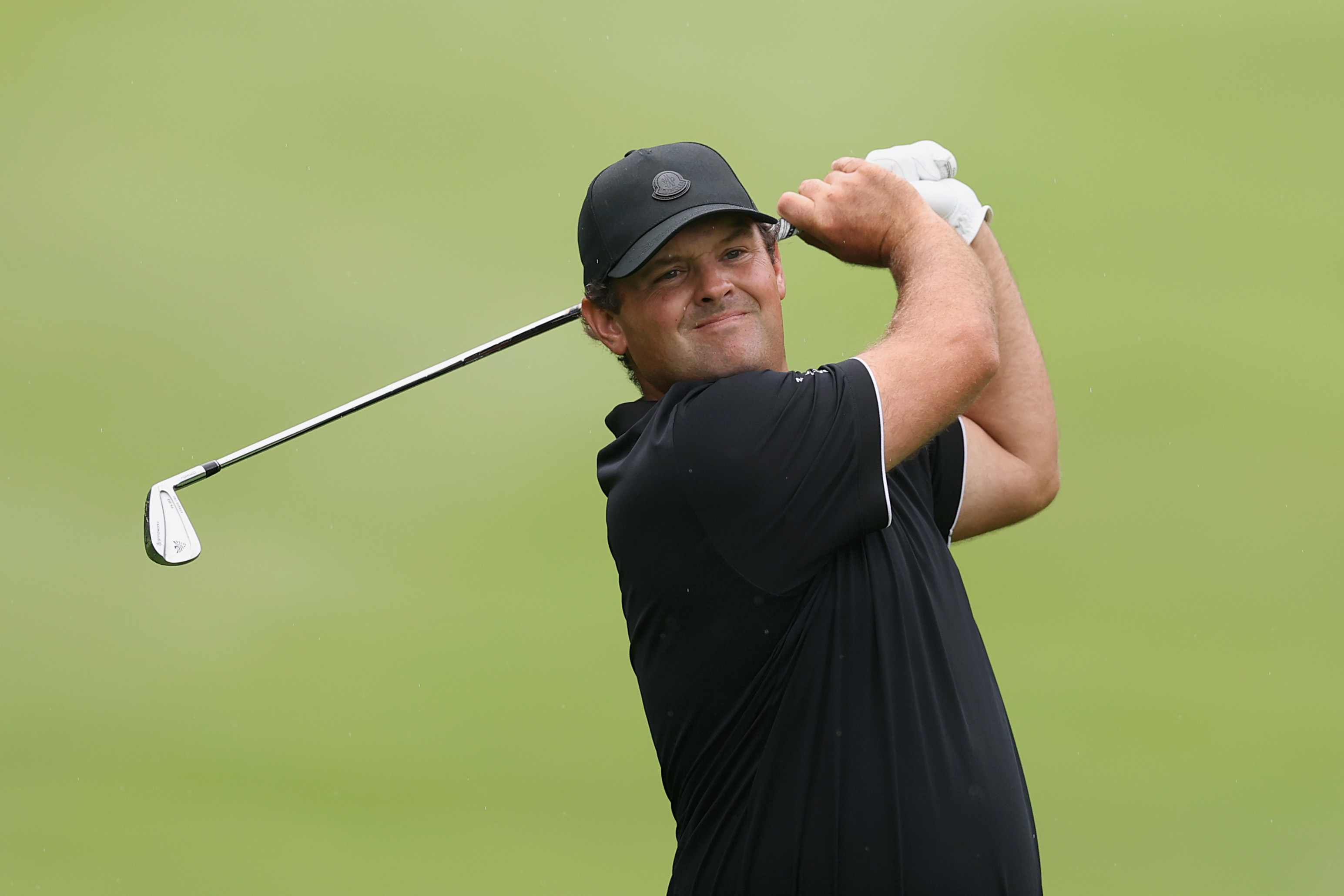 Patrick Reed hits an iron shot and watches its flight