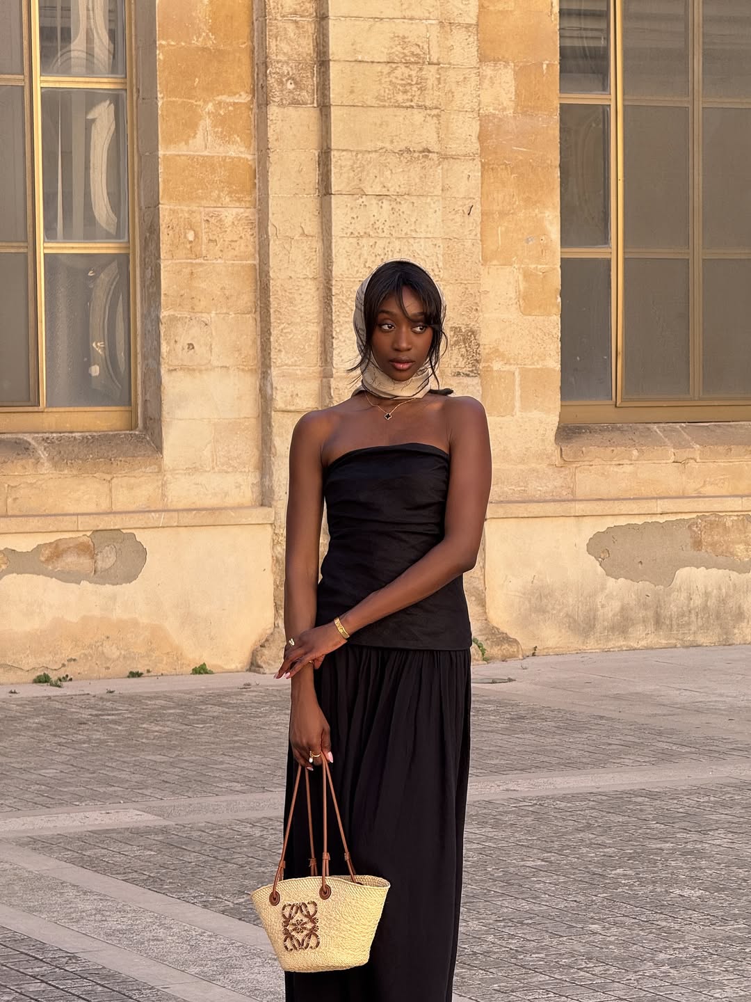@emmanuellek_ wears a black bandeau dress, headscarf and basket bag