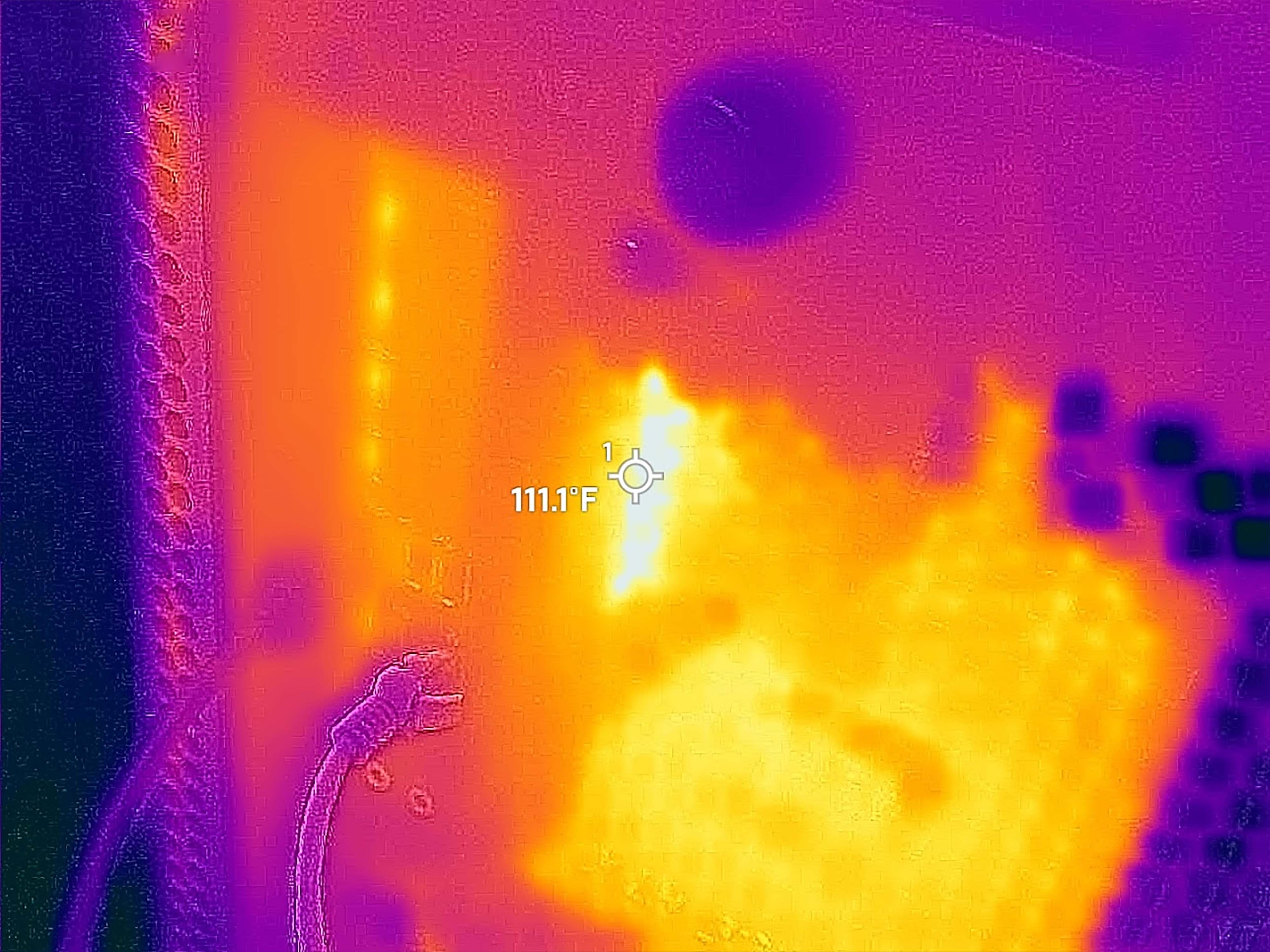 Photo taken with a thermal camera that shows the Area-51 Desktop's back vent peaking at 111 degrees F.