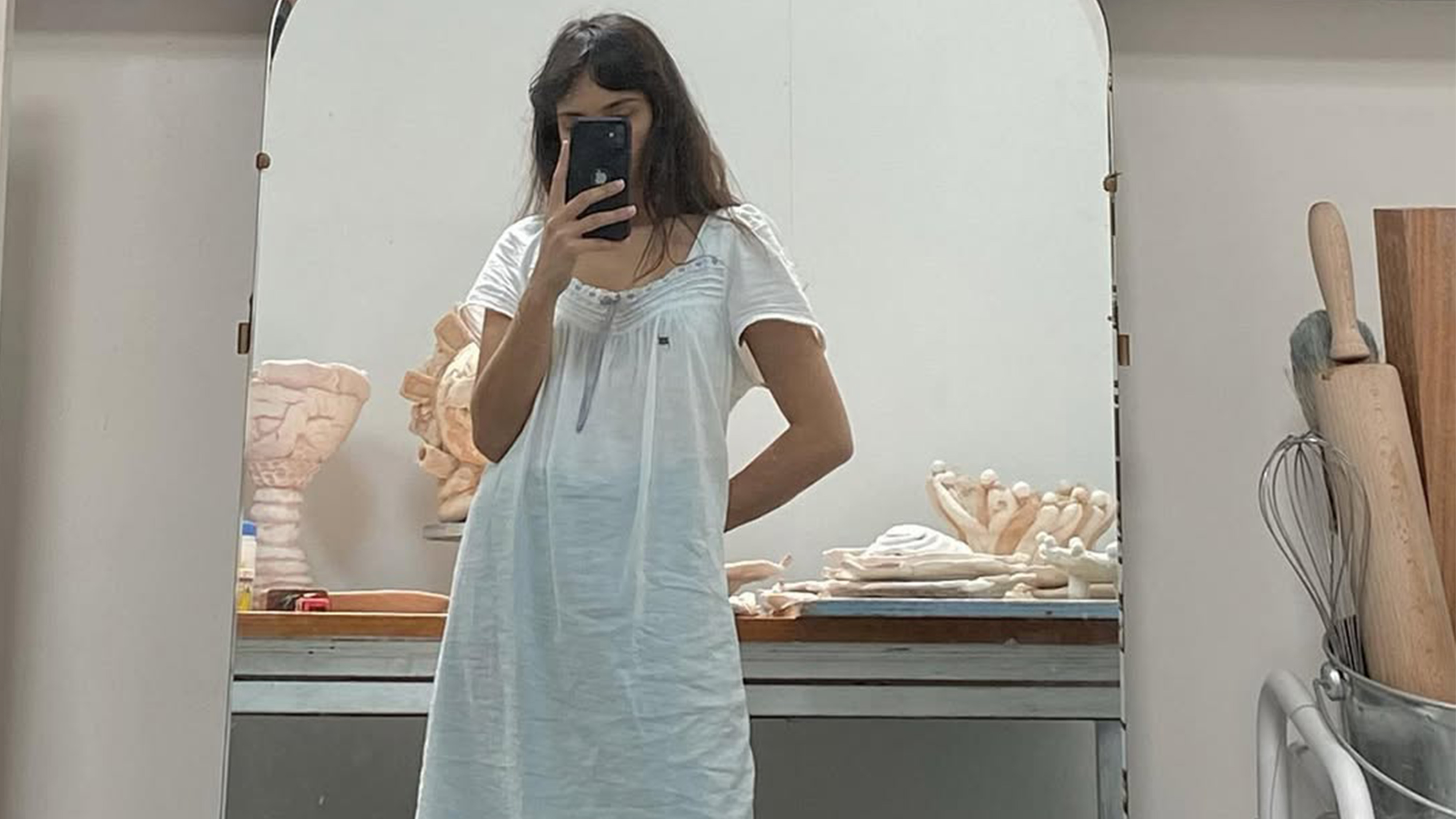 Seala Lokollo wearing a white dress.