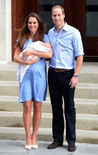 Prince William, Duke of Cambridge and Catherine, Duchess of Cambridge with their newborn son pose for the media