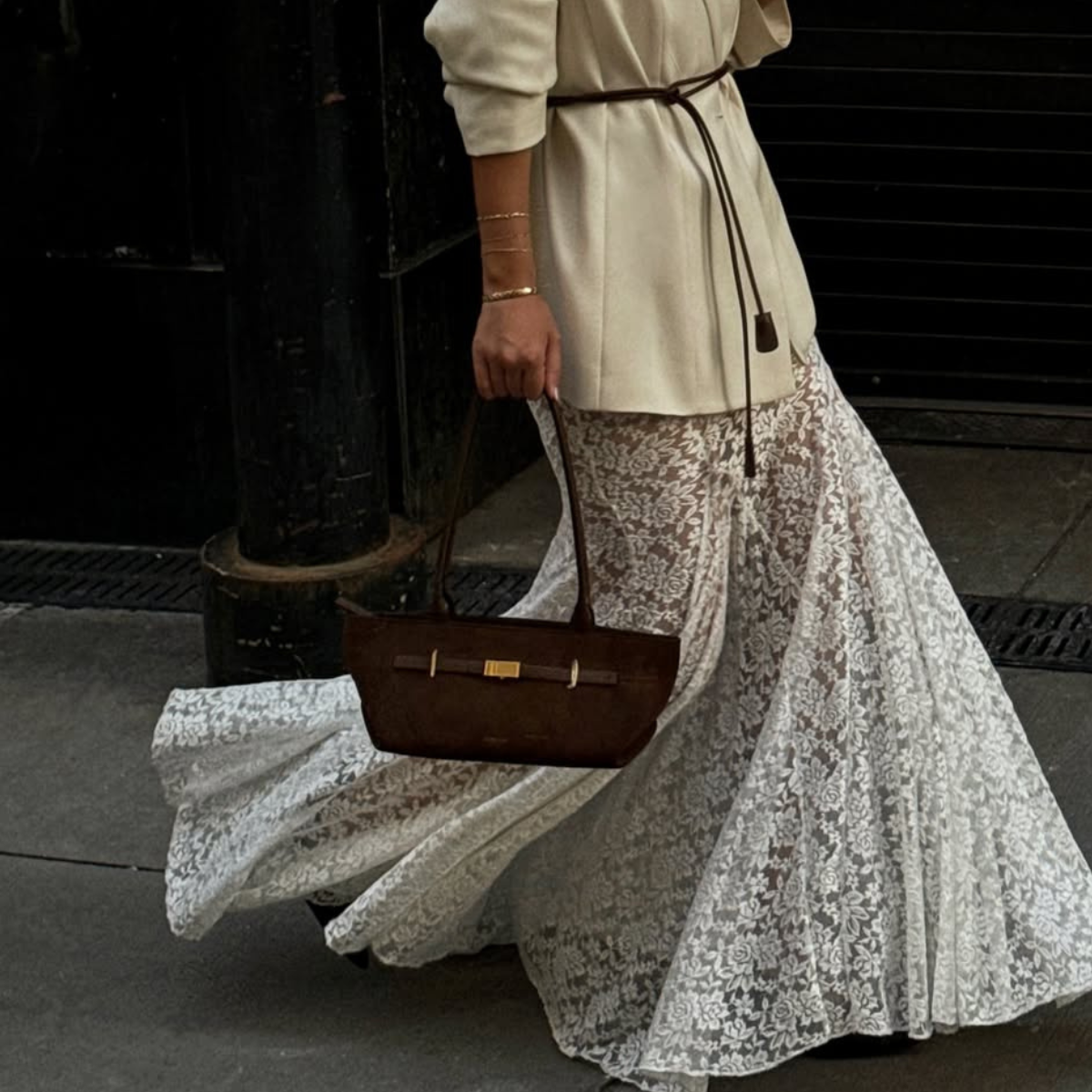 Caroline carrying a brown DeMellier handbag
