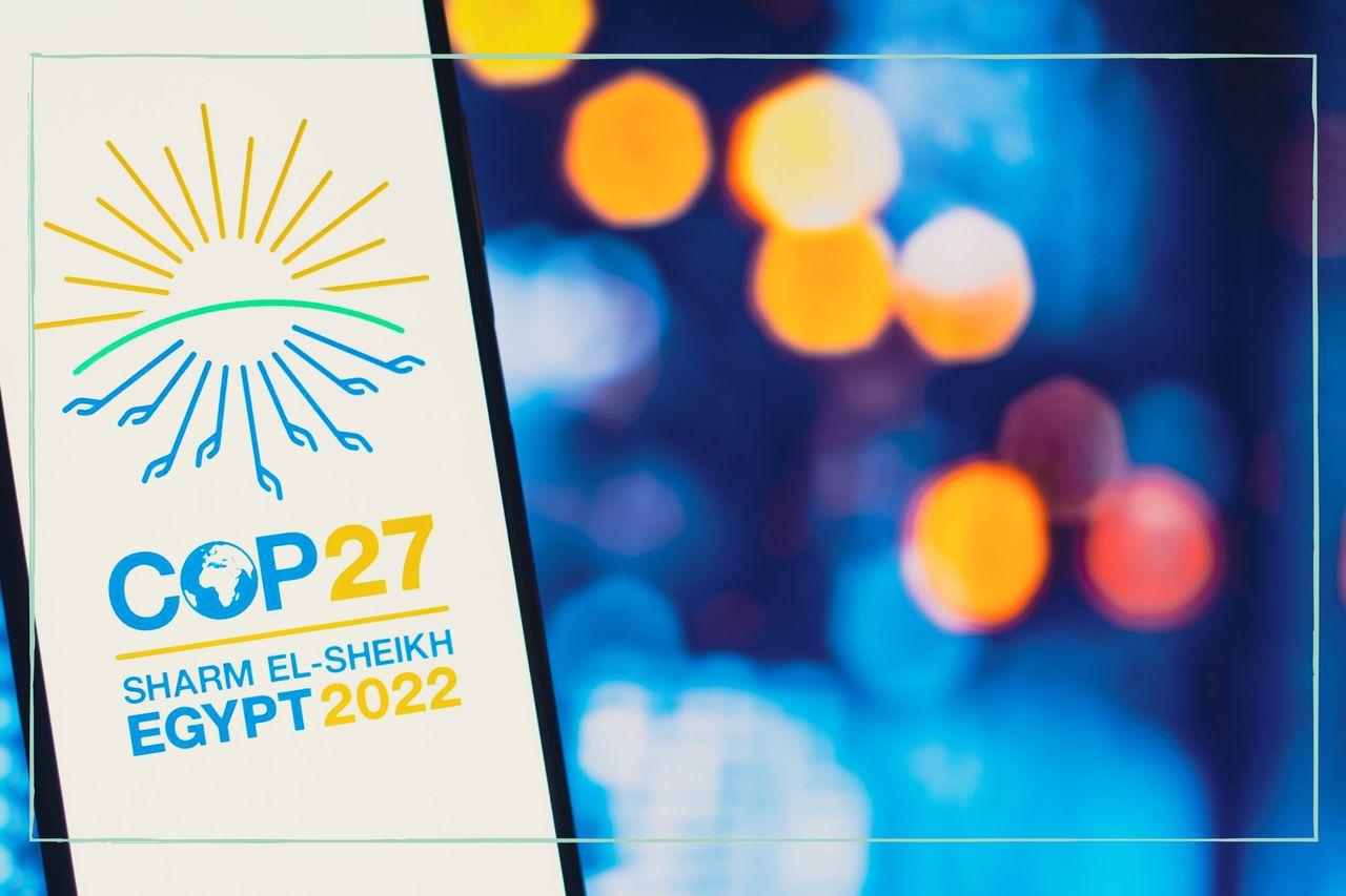 A yellow and blue COP27 logo on a phone screen