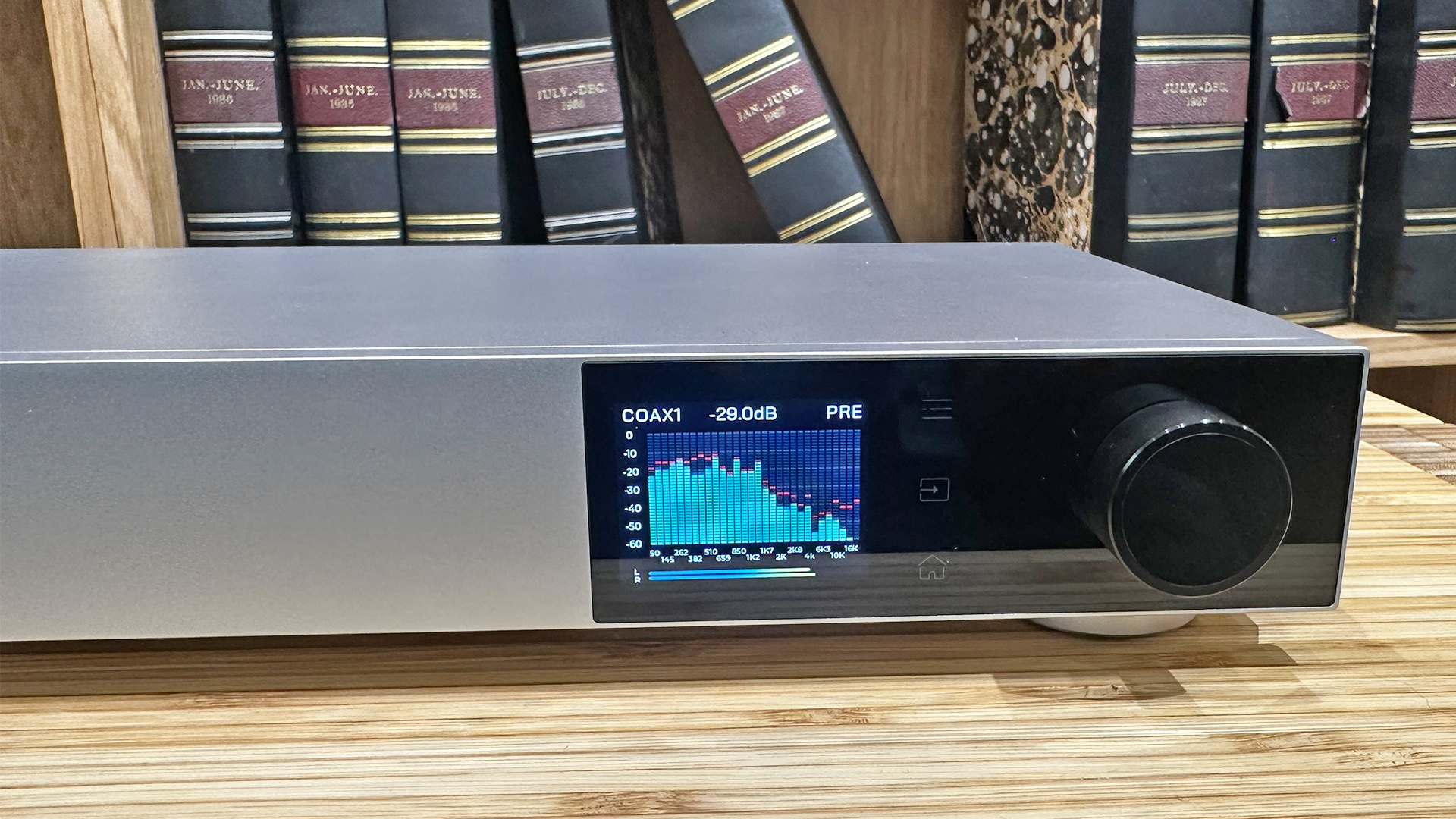Topping Audio D900 DAC on wooden hi-fi rack in front of bookcase, on display is EQ