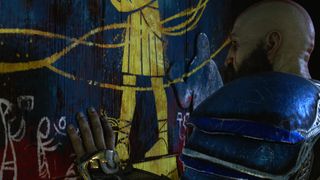 God of War Ragnarok's Kratos touches a painted shrine