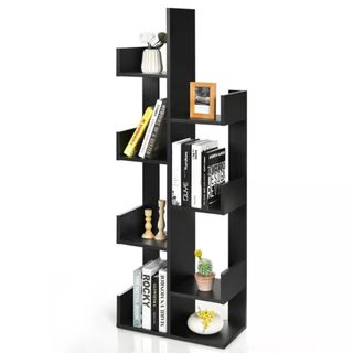 A black tree-style bookcase is filled with books and other objects