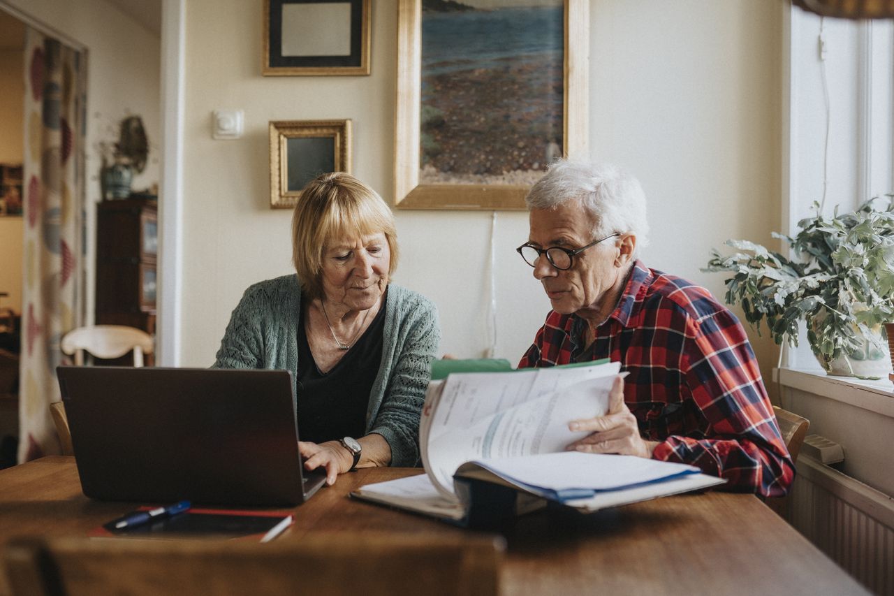 Senior couple using laptop at home