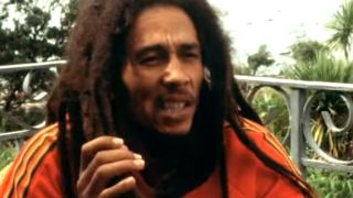 Bob Marley being interviewed on a porch.