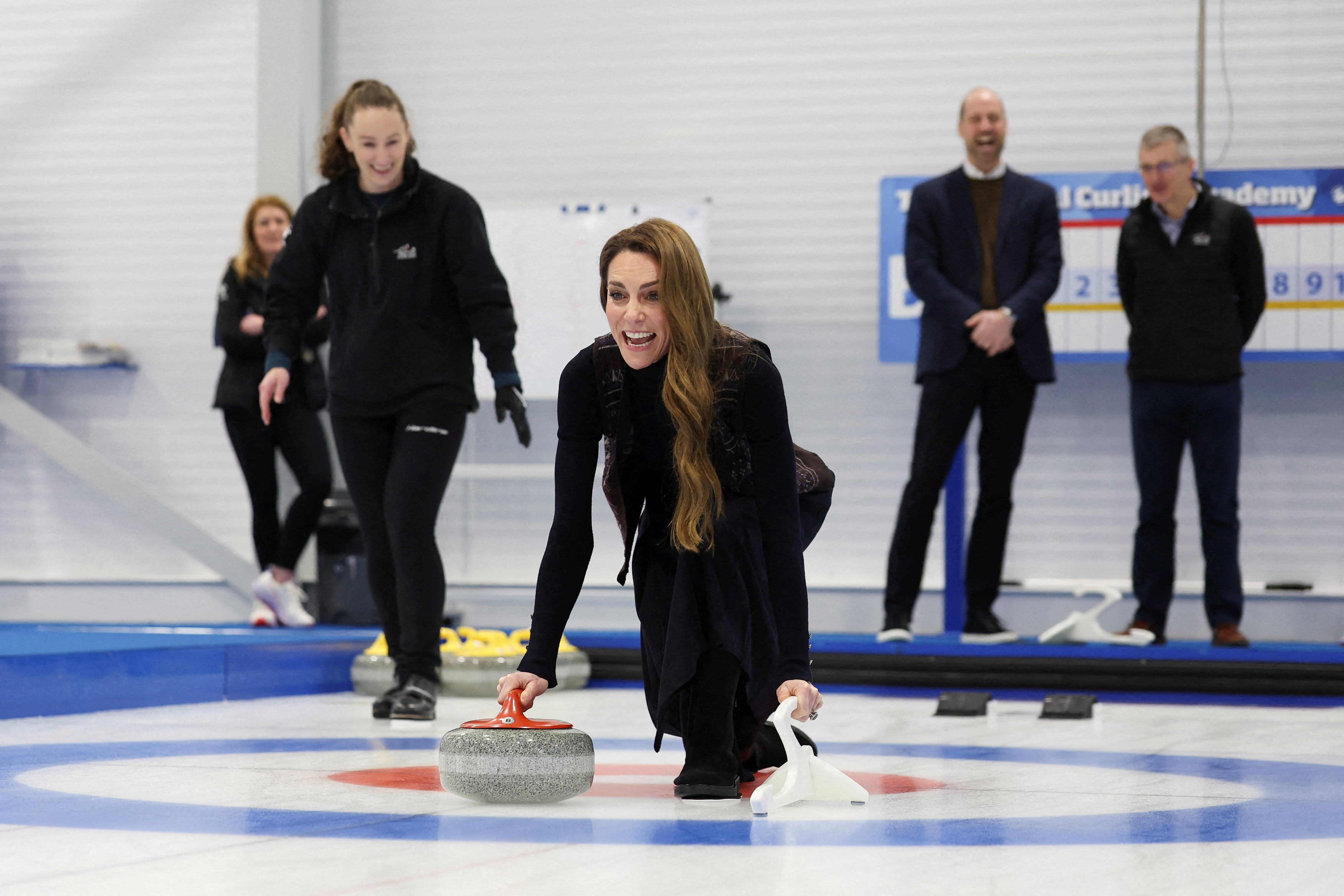 Catherine, Princess of Wales takes part in curling during a visit to meet with the Team GB and Paralympics GB Curling teams.