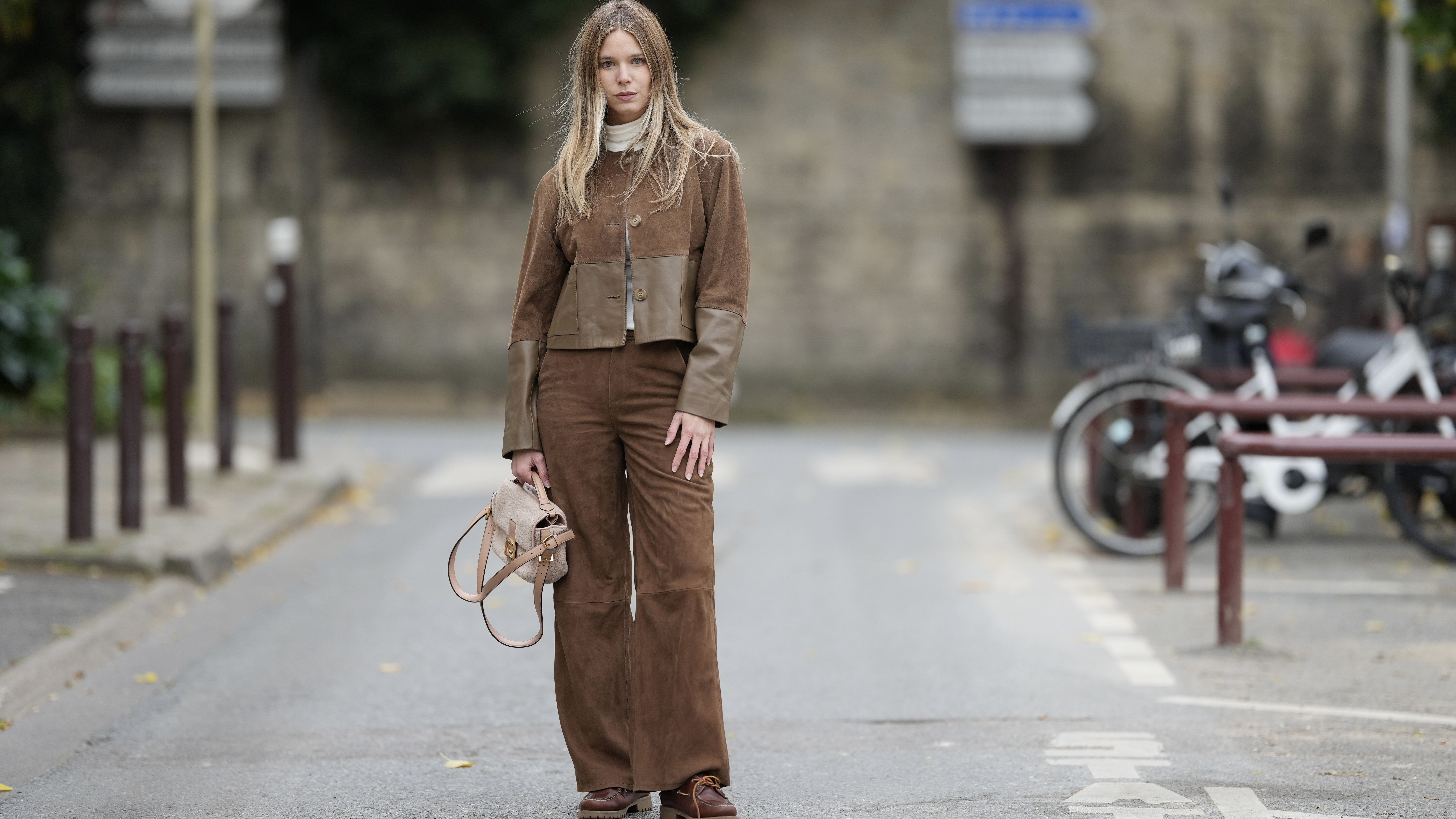 woman wearing head to toe brown suede with a jacket and pants