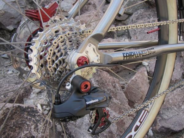 The tuned Di2 rear derailleur moves the KMC chain across a SRAM XX cassette.