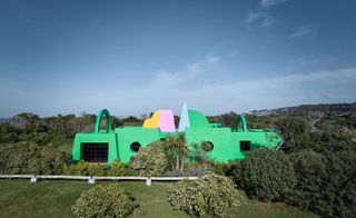 green artist house Casa Neptuna set in green landscape