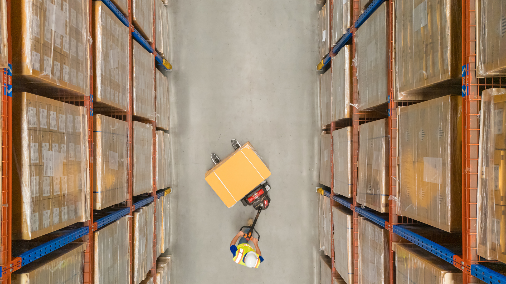 person pushing trolley through warehouse
