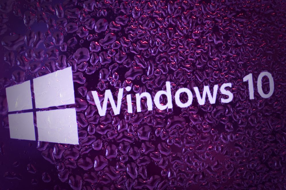 Microsoft&amp;#039;s flagship OS Windows 10 on a purple graphic