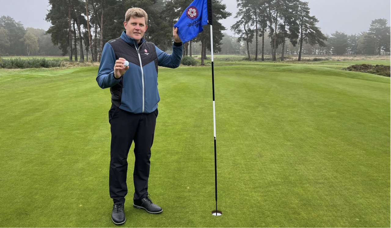 PGA Head Pro Adam Keogh poses on the 18th green at Woodhall Spa Golf Club while holding onto his ball and the flag