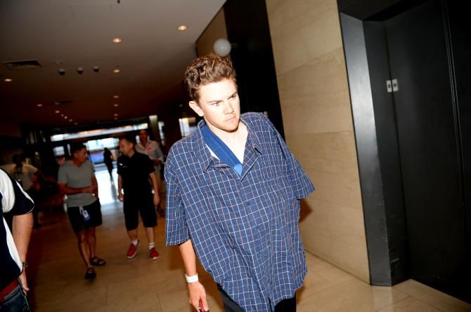 Campbell Flakemore heads to his hotel room after breaking his collarbone