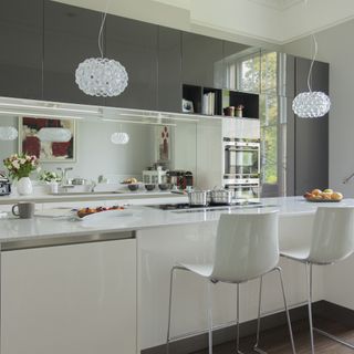 kitchen with white worktop and statement lights