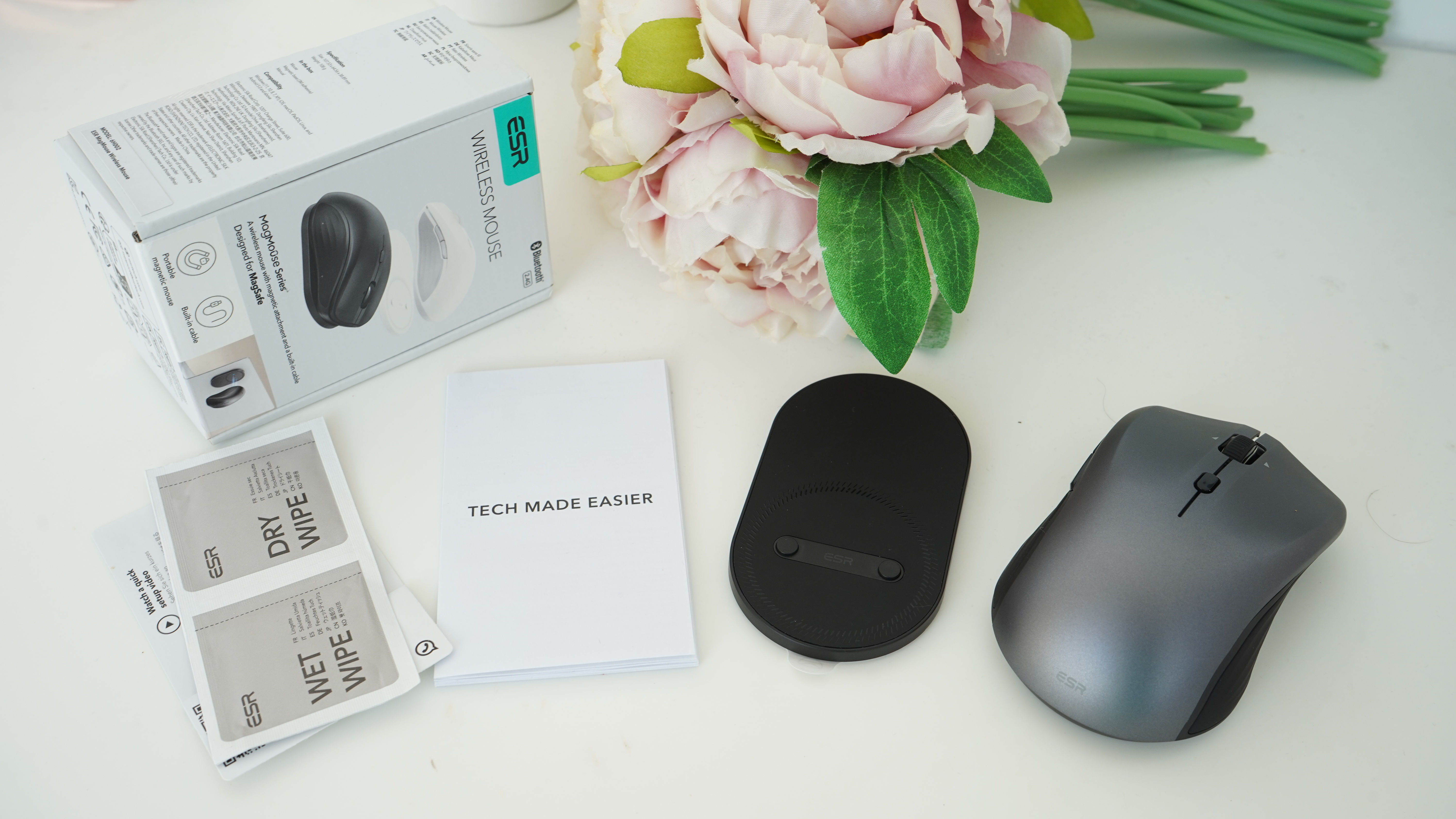 ESR MagMouse magnetic mouse and the box with accessories next to some flowers