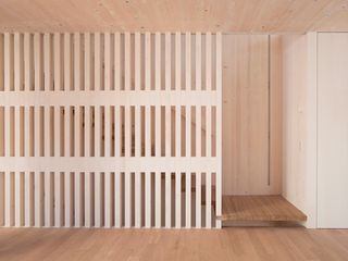 Inside Sunlighthouse: A wooden screen provides a decorative effect in the main living area