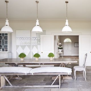 dining area with wooden dining table and white walls