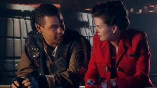 Still from the British sci-fi sitcom called Red Dwarf. Here we see Lister and Kristine Kochanski leaning on a barrier, chatting.