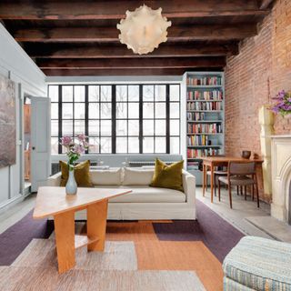 living room with exposed brick walls and wooden table