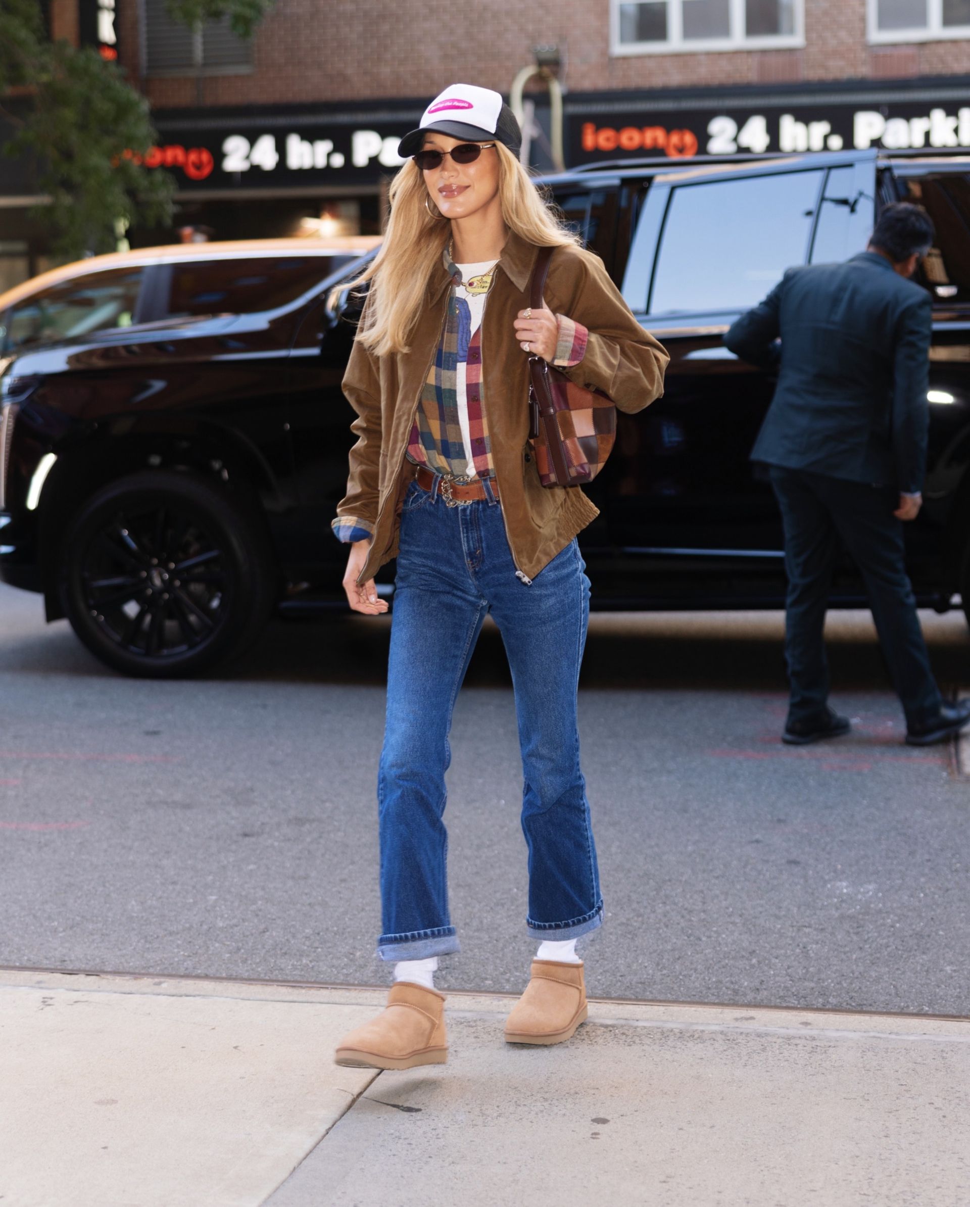 Bella Hadid in a suede jacket, jeans, and uggs