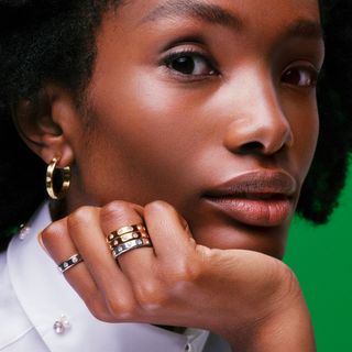 model wearing silver and gold rings