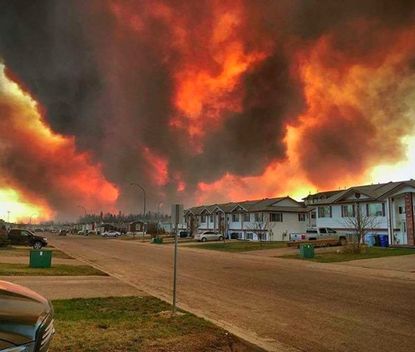 Smoke and flames near Fort McMurray, Alberta, Canada.