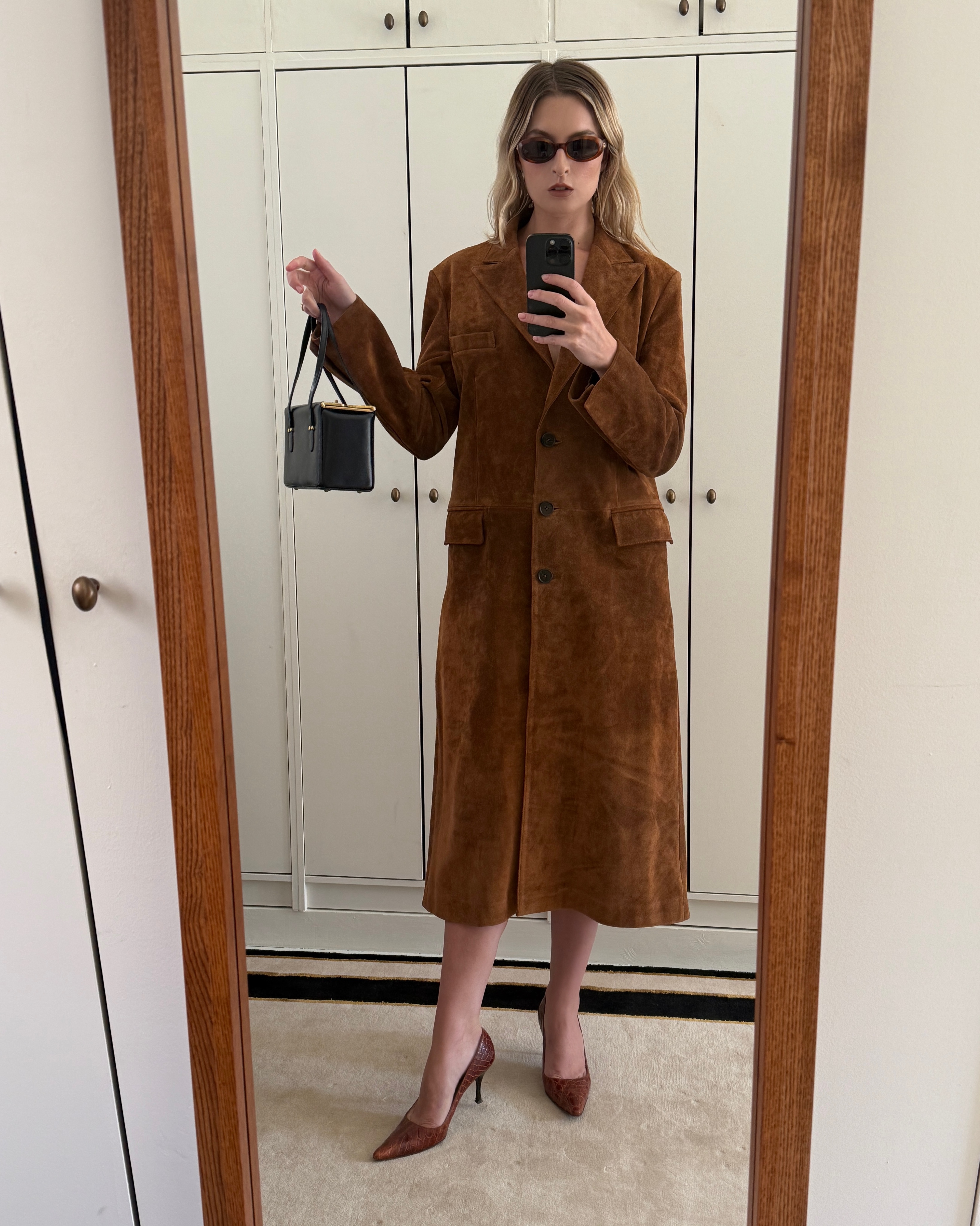 Christie Tyler wearing a suede brown jacket