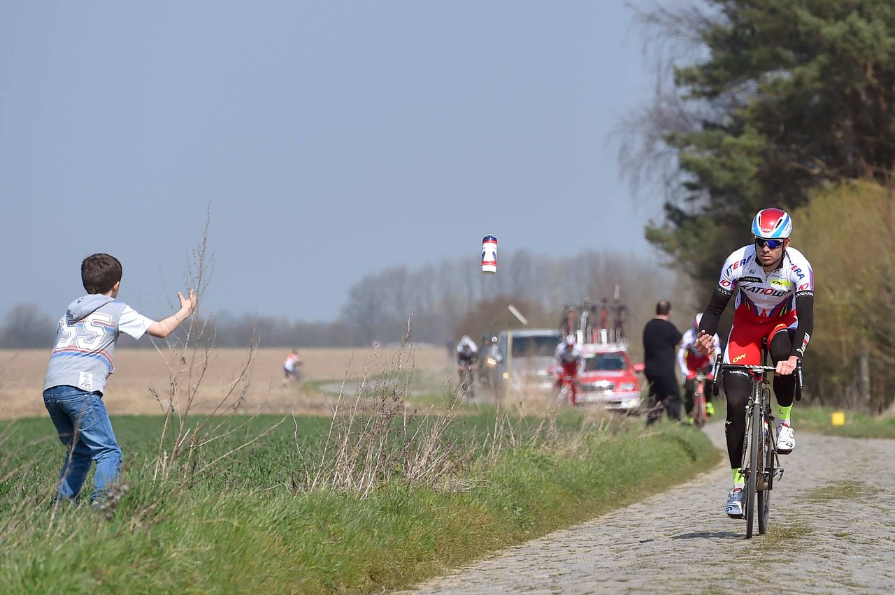 Alexander Kristoff (Katusha) tosses a bottle to a fan