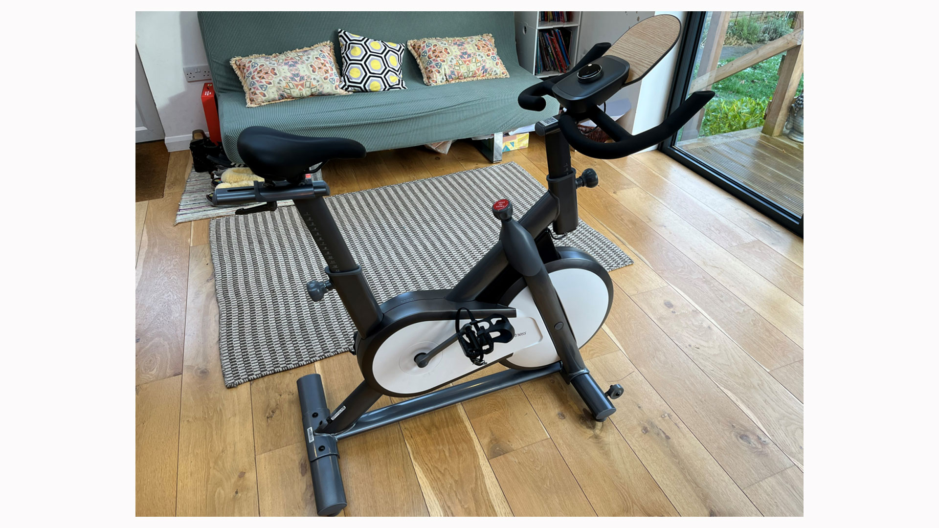 The image shows a side view of the Moby Turbo exercise bike.