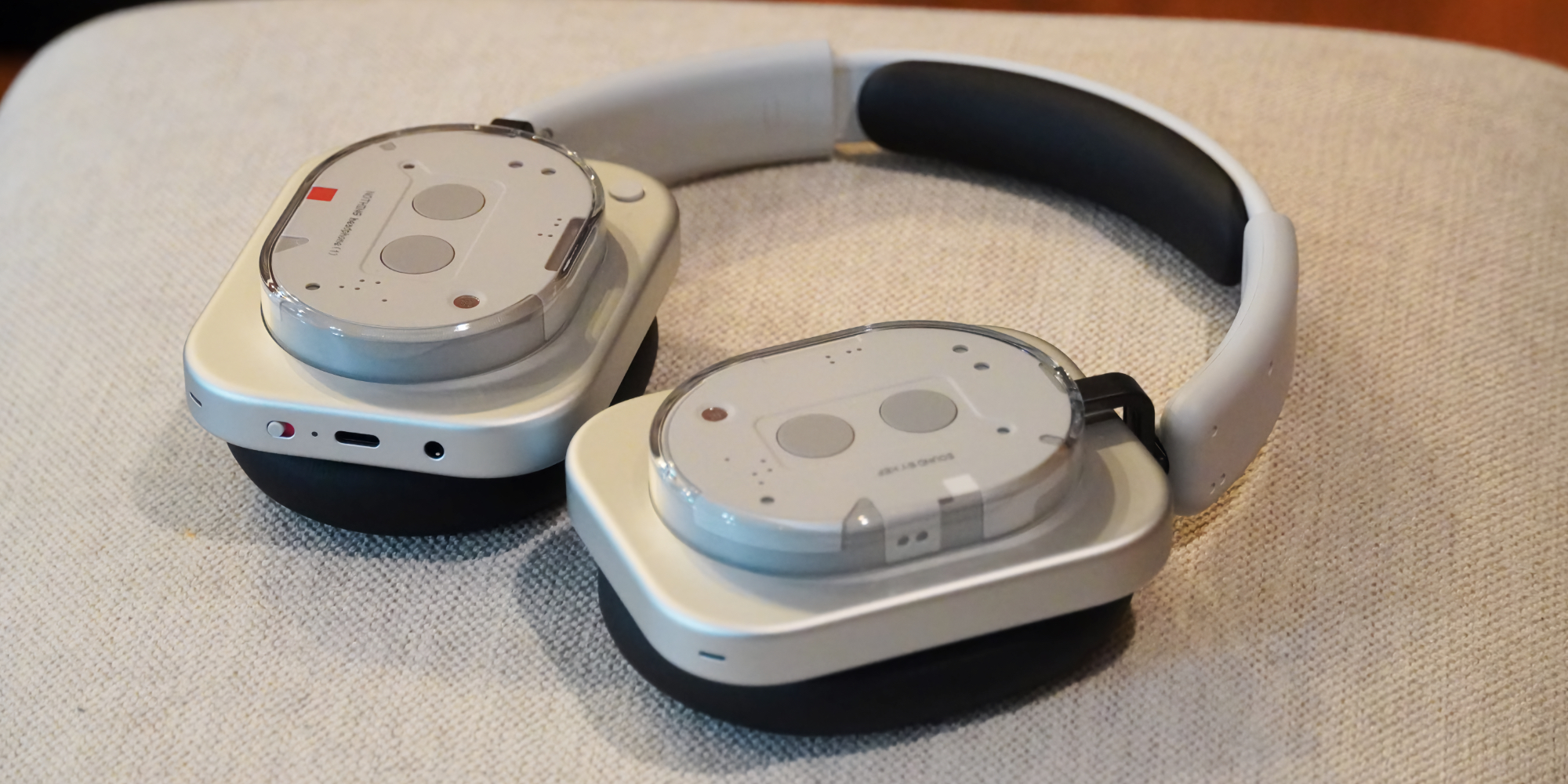 The Nothing Headphone 1 lying on a stool showing the design and ports.