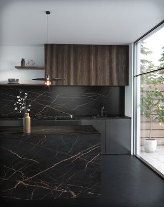 Modern kitchen ideas in black veined marble, with panelled wooden cabinetry.