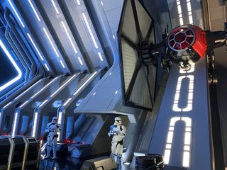 The deck of the Star Destroyer is massive. A group of stormtroopers stands in front of you; a TIE fighter hangs to the right.