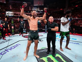 dustin jacoby celebrating in an UFC ring