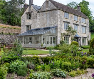 Conservatory on side of grey stone house