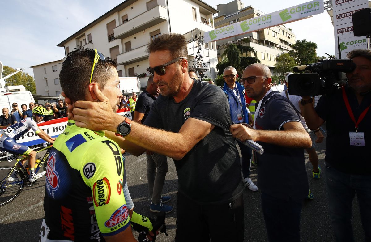 Visconti celebrates with his soigneur after the race