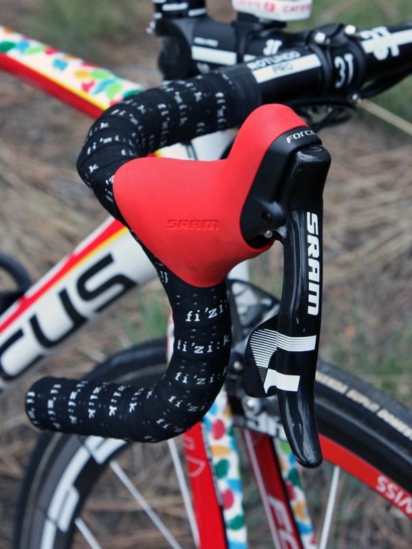 SRAM Force DoubleTap levers are wrapped with bright red hoods.