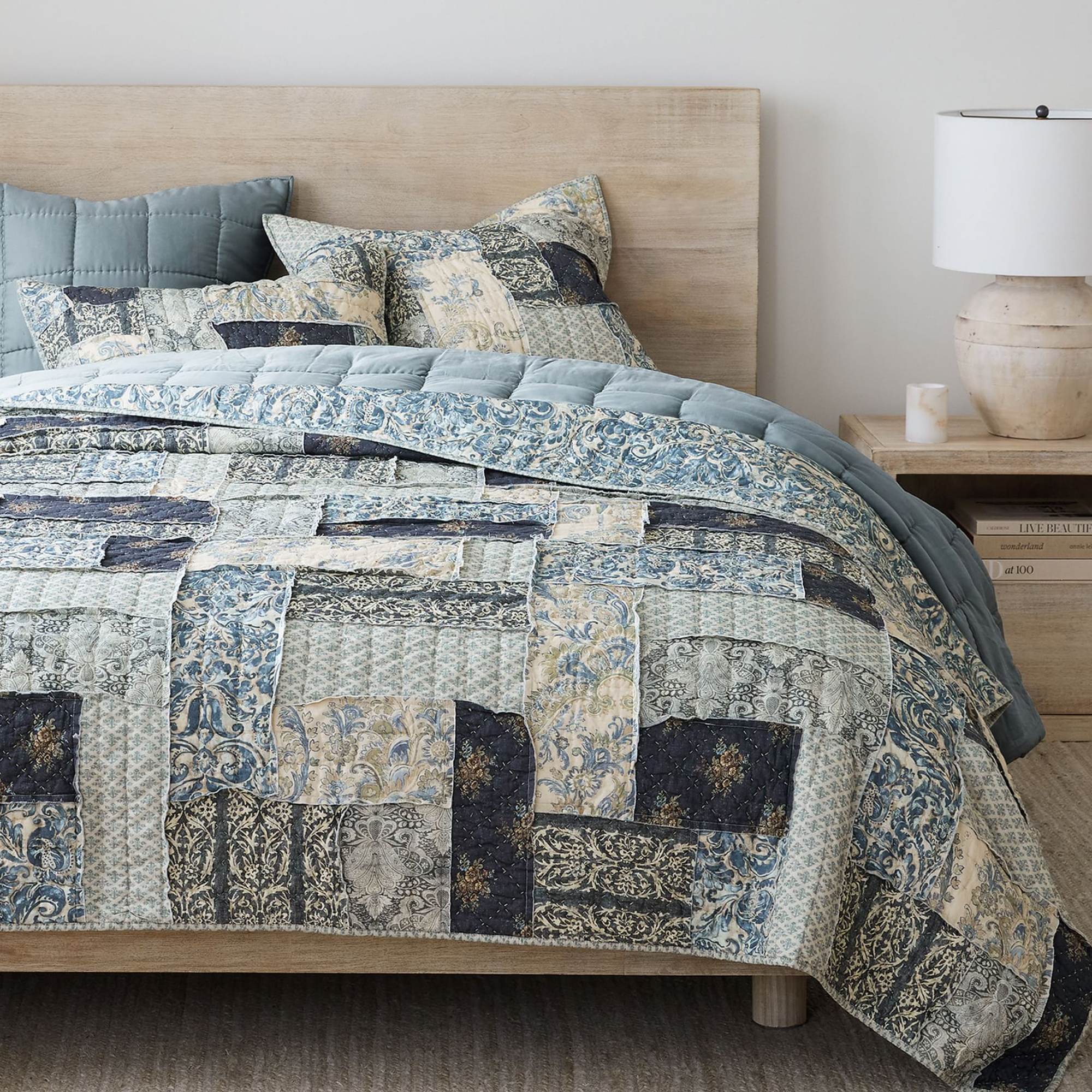 blue patchwork quilt on a bed