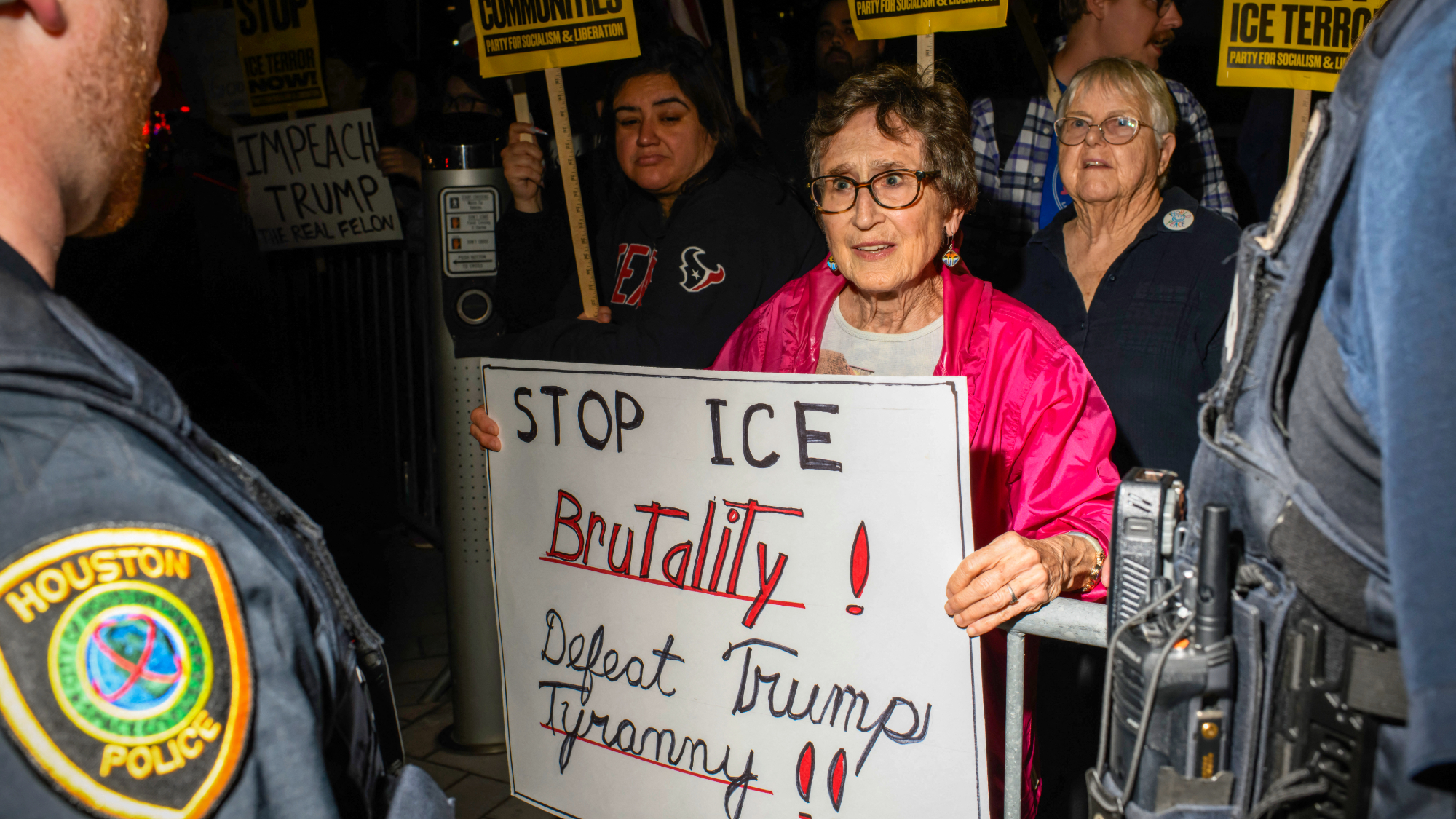 Houston Police officers keep an eye on demonstrators during a protest against ICE in Houston in January 2026