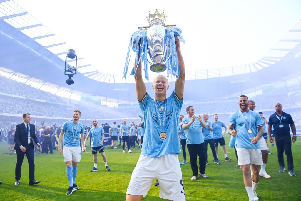 Manchester City&#039;s Erling Haaland celebrating with the Premier League trophy