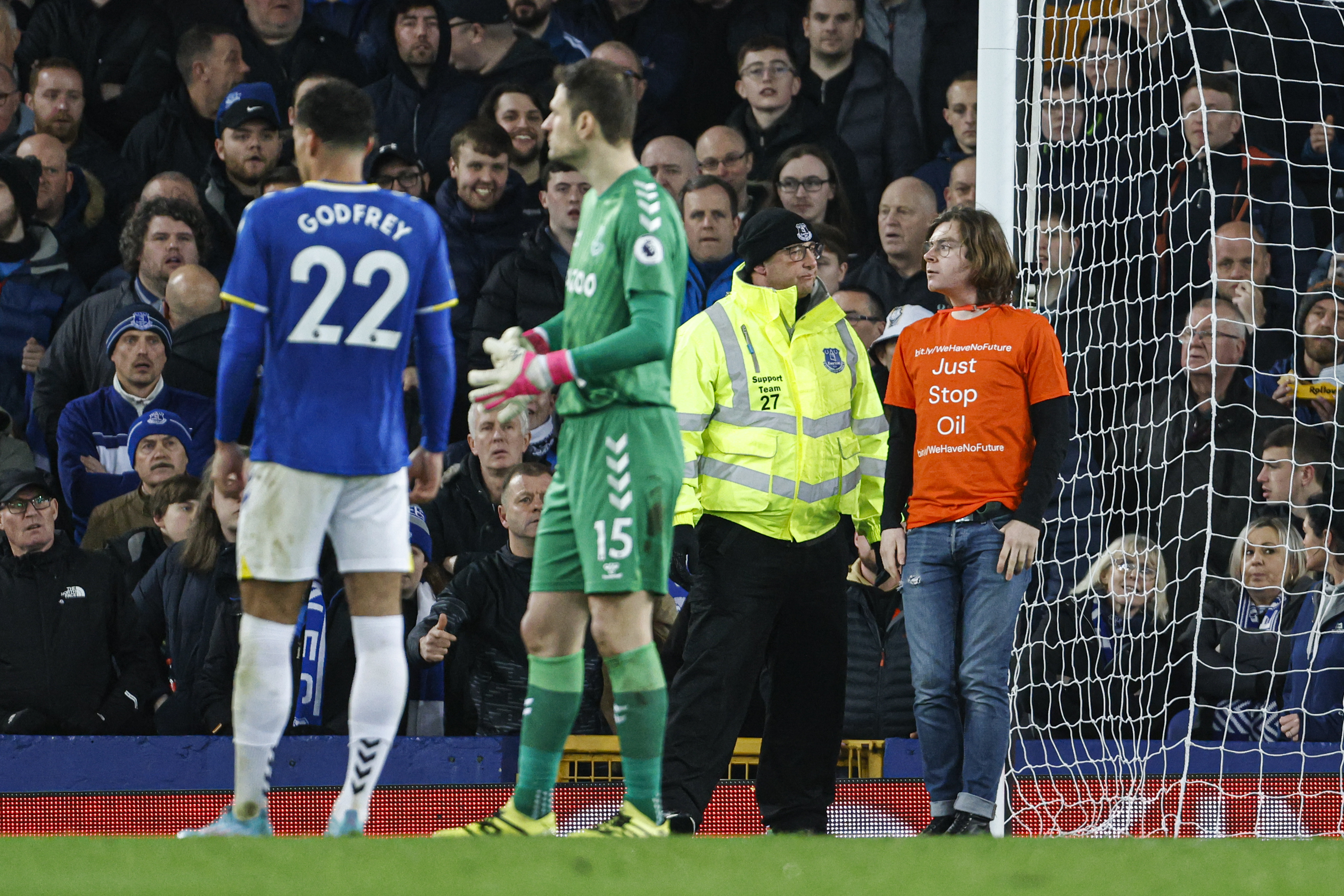 A protester ties himself to a post at Goodison Park